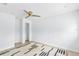 Bright bedroom featuring a ceiling fan, clean white walls, and light hardwood flooring at 1921 Dartmouth Ave, Winter Park, FL 32789