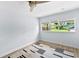 Bright bedroom featuring a window, clean white walls, and light hardwood flooring at 1921 Dartmouth Ave, Winter Park, FL 32789