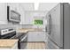 Modern kitchen boasts stainless steel appliances, bright white cabinets, and stylish countertops at 1921 Dartmouth Ave, Winter Park, FL 32789