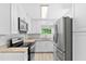 Modern kitchen boasts stainless steel appliances, bright white cabinets, and stylish countertops at 1921 Dartmouth Ave, Winter Park, FL 32789