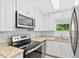 Modern kitchen boasts stainless steel appliances, bright white cabinets, and stylish countertops at 1921 Dartmouth Ave, Winter Park, FL 32789