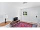 Bright living room with light walls, wood floor, and a colorful rug at 1921 Dartmouth Ave, Winter Park, FL 32789