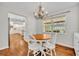 Charming dining area with a wooden table and white chairs, bathed in natural light from a large window at 1930 Aster Dr, Winter Park, FL 32792