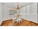 Dining area with natural light, round wood table, and custom-built cabinets at 1930 Aster Dr, Winter Park, FL 32792