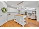 Open kitchen with a butcher block island, white cabinetry, stainless appliances, and view into the living room at 1930 Aster Dr, Winter Park, FL 32792