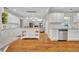 Spacious kitchen with an island, granite countertops, and open layout into the adjacent living room at 1930 Aster Dr, Winter Park, FL 32792