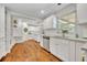 Beautiful kitchen with white cabinets, granite countertops, and hardwood floors, flowing into the breakfast nook at 1930 Aster Dr, Winter Park, FL 32792