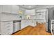 Bright kitchen featuring white cabinets, stainless steel appliances, granite countertops, and hardwood flooring at 1930 Aster Dr, Winter Park, FL 32792