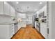Updated kitchen featuring stainless steel appliances, white cabinets, and hardwood flooring, creating a bright and modern space at 1930 Aster Dr, Winter Park, FL 32792
