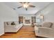 Spacious living room with a ceiling fan, fireplace, and natural light at 1930 Aster Dr, Winter Park, FL 32792