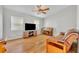 Living room with a ceiling fan, large television, and a piano at 1930 Aster Dr, Winter Park, FL 32792