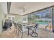 Covered patio area with table and chairs overlooking the screened in pool and back yard at 1930 Aster Dr, Winter Park, FL 32792