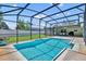 Beautiful screened-in pool and patio area with a table and chairs creating an ideal outdoor entertaining space at 1930 Aster Dr, Winter Park, FL 32792