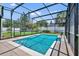 In-ground pool featuring screened enclosure, patio and garden area along the white fence at 1930 Aster Dr, Winter Park, FL 32792