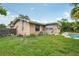 Spacious backyard featuring lush green grass, an exterior brick house, and access to the pool at 2020 Cocos Ct, Winter Park, FL 32792