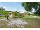Suburban home with a well-maintained lawn, mature trees, and a detached two car garage at 2020 Cocos Ct, Winter Park, FL 32792