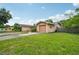 Home exterior with attached garage and driveway showcasing the landscaping around the property at 2020 Cocos Ct, Winter Park, FL 32792