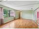 Well-lit living room featuring hardwood floors, large windows, and access to an enclosed porch at 2020 Cocos Ct, Winter Park, FL 32792