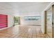 Large living room with tile flooring, a pink bookshelf, and large windows at 2020 Cocos Ct, Winter Park, FL 32792