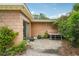Covered outdoor patio area with concrete flooring, sliding glass door, and flourishing greenery at 2020 Cocos Ct, Winter Park, FL 32792