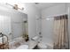 Bathroom featuring granite countertops, modern lighting, and a bathtub with a shower at 2305 Ascot Ave, Orlando, FL 32833