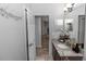 Bathroom featuring granite countertops, a large mirror, and modern fixtures at 2305 Ascot Ave, Orlando, FL 32833
