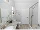 Bathroom featuring granite countertops, a glass shower door, and modern fixtures at 2305 Ascot Ave, Orlando, FL 32833