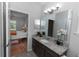 Stylish bathroom featuring granite countertops, a large mirror, and modern lighting at 2305 Ascot Ave, Orlando, FL 32833