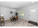 Modern dining room with stylish chandelier, wood-look flooring, and a view to the front yard at 2305 Ascot Ave, Orlando, FL 32833
