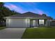 Charming single-story home with a manicured lawn, attached garage, and inviting front porch at 2305 Ascot Ave, Orlando, FL 32833