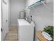 Bright laundry room with washer, dryer, water heater, and overhead storage shelf at 2305 Ascot Ave, Orlando, FL 32833