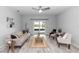Bright living room with neutral decor, ceiling fan, and sliding glass doors to the patio at 2305 Ascot Ave, Orlando, FL 32833