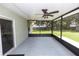 Enclosed screened porch featuring a ceiling fan and views of the backyard at 2305 Ascot Ave, Orlando, FL 32833