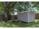 Durable storage shed in the backyard with shade from a large tree at 2305 Ascot Ave, Orlando, FL 32833
