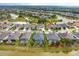 Aerial view of home with screened pool and water view in a neighborhood at 2440 Pawtucket Pass, Mount Dora, FL 32757