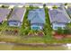 Home with a screened pool, back yard landscaping and view of a lake at 2440 Pawtucket Pass, Mount Dora, FL 32757