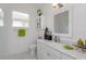 Clean and bright bathroom featuring white cabinets, marble countertops and modern fixtures at 2440 Pawtucket Pass, Mount Dora, FL 32757