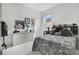 Stylish black and white bedroom featuring unique decor and a comfortable looking bed at 2440 Pawtucket Pass, Mount Dora, FL 32757