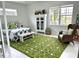 Serene bedroom with large windows, a cozy chair, and bright natural light, creating a relaxing atmosphere at 2440 Pawtucket Pass, Mount Dora, FL 32757