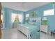 Serene bedroom with soft blue walls, white furniture, and plenty of natural light at 2440 Pawtucket Pass, Mount Dora, FL 32757