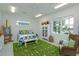 Inviting bedroom featuring bright accents, wicker chair, large window, and serene ambiance at 2440 Pawtucket Pass, Mount Dora, FL 32757
