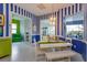Dining area featuring a white table, blue and white striped walls, and a view of the landscaped backyard at 2440 Pawtucket Pass, Mount Dora, FL 32757