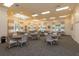 Large dining room with ample seating, decorative chandeliers and neutral color palette at 2440 Pawtucket Pass, Mount Dora, FL 32757