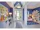 Entryway with blue walls, white trim, modern lighting and view to a seating area at 2440 Pawtucket Pass, Mount Dora, FL 32757