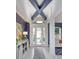 Inviting foyer features stylish decor, blue accent walls, and a decorative light fixture at 2440 Pawtucket Pass, Mount Dora, FL 32757
