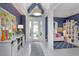 Charming foyer features blue accent walls and a view into the adjacent living area at 2440 Pawtucket Pass, Mount Dora, FL 32757