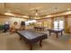 Spacious game room featuring multiple billiard tables, pendant lighting, and a relaxed ambiance for entertainment at 2440 Pawtucket Pass, Mount Dora, FL 32757