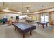 Features three pool tables in game room complete with ceiling fans, lighting, seating and decor at 2440 Pawtucket Pass, Mount Dora, FL 32757