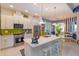 Bright kitchen featuring white cabinetry, stainless steel appliances, and a spacious island with seating at 2440 Pawtucket Pass, Mount Dora, FL 32757