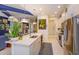 Modern kitchen boasting stainless steel appliances, an island with seating, and stylish lighting fixtures at 2440 Pawtucket Pass, Mount Dora, FL 32757